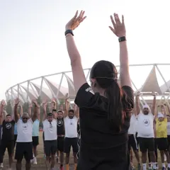 Leading a dynamic warm-up session. I teach runners to move away from static stretching before a run and focus on movements that activate key muscles and improve mobility.