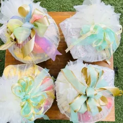 My full-service trousseau packing focuses on the details. Here, I've used delicate net wrapping with multi-colored pastel and gold ribbons to bundle gifts, creating an elegant and cohesive look for the gift exchange ceremony.