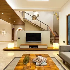 In this open-plan living area, we used a low-profile TV console to maintain an airy feel, with the staircase creating a dramatic visual backdrop. The space is designed for flow and connection, perfect for modern family living.