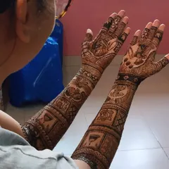 A full bridal design from a different angle, showing how the story unfolds from the palms up to the elbows with various traditional figures.