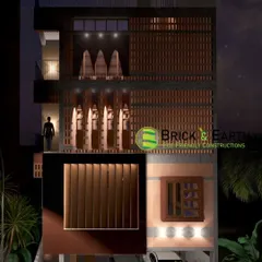 A night-view render of the same eco-friendly building. This helps in planning the exterior lighting to highlight architectural features like the brick jali work and create a welcoming ambiance.