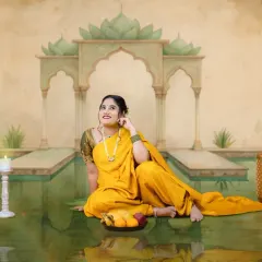For those who love tradition, we offer creative sessions inspired by classic Indian art. This mom-to-be is styled in a beautiful yellow saree for a fine art maternity portrait that feels like a timeless painting, celebrating our rich cultural heritage.