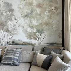 A close-up of the artisanal landscape wallpaper, showing the delicate brushstrokes and subtle color variations that give it a hand-painted feel. This mural brings natural beauty and meticulous craftsmanship into the home.