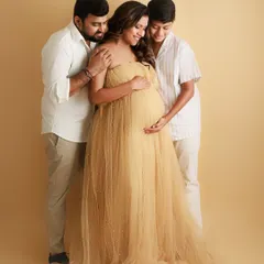 A maternity session is a celebration for the whole family. Here, big brother and dad surround mom with so much love, eagerly awaiting the arrival of the new baby.