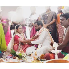 Capturing the quiet solemnity of a South Indian wedding ceremony. I focus on the meaningful details, like the exchange between the couple, surrounded by the vibrant colors of their family and traditions.
