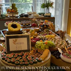 Another angle of our grand grazing table for a furniture showroom inauguration. We use height and texture, with tiered stands and varied platters, to create a dynamic and inviting spread that encourages guests to mingle and graze.