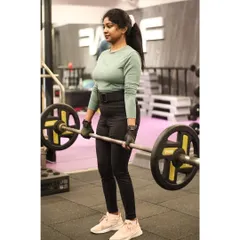 A member executes a deadlift with a barbell, a powerful compound exercise that builds strength across the entire posterior chain, including the back, glutes, and hamstrings.