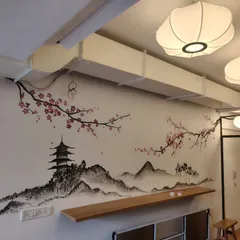 For this Japanese-themed cafe, I painted a subtle, sketch-like cherry blossom landscape. The design includes a Japanese prayer for prosperity and happiness, creating a peaceful and authentic atmosphere.