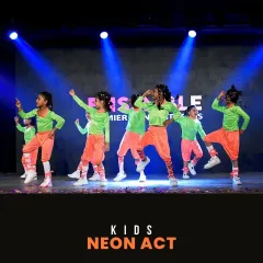 The Kids Neon Act from 'ON-STAGE '25'. The vibrant costumes pop under the stage lights as the children perform a dynamic hip-hop inspired routine they learned in our classes.