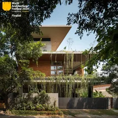 The exterior of the 'House of Greens' showcases my passion for biophilic architecture. Cascading greenery drapes over the concrete facade, creating a living skin that cools the home and blurs the boundary between the building and the landscape. This approach turns a simple residence into a natural sanctuary within the city.