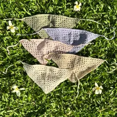 Our crochet bandanas are available in a variety of colors. This flat lay shows some of our favorite pastel and neutral shades, perfect for any season.