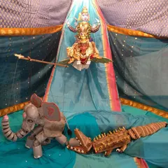 A scene from the Gajendra Moksha story, depicted with our handcrafted puppets. This display showcases the intricate detail and expressive artistry that goes into each character, from the divine form of Vishnu to the elephant and crocodile.