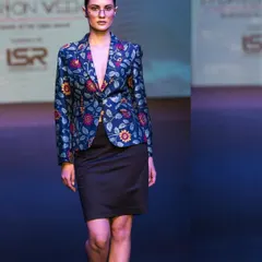 Capturing a modern, structured look on the runway. This image highlights a floral blazer and the model's strong presence, demonstrating my ability to freeze key moments during a fashion show.