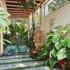A client's lush entryway featuring our standing Ganesha statue. Paired with our antique sea green planters, it creates a welcoming space that blends spiritual art with natural beauty.