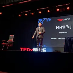 On the iconic red circle, delivering a talk at TEDxNHCE. Being a four-time TEDx speaker has honed my ability to blend complex ideas with illusion, creating keynote presentations that are both engaging and deeply memorable for any corporate audience.