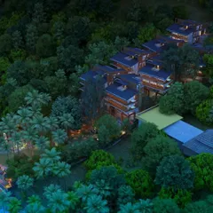 An aerial view of the Atmanya boutique resort in Goa at dusk, a design that harmonizes with its lush, waterfront landscape to create a tranquil and immersive natural retreat.
