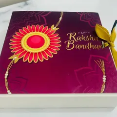 The beautiful Rakhi-themed packaging I use for my gift boxes. This sleeve with a floral rakhi design adds a special festive touch to your present.