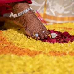 A close-up of a beautiful dark stain on the feet. The intricate patterns look even more stunning when the color fully develops, as seen here against a bed of flower petals.