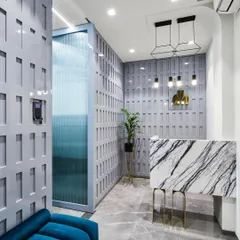A first impression matters. This reception area for the 'Greywood Loft' project was designed to be unforgettable, featuring a statement marble desk, custom geometric wall paneling, and dramatic pendant lighting.