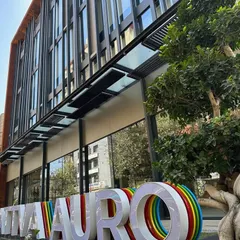 A duplicate image showing the entrance and signage of the Sattva Auro building.