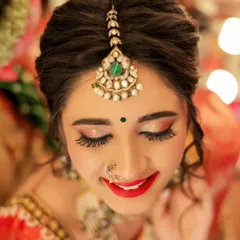 For beauty and makeup portfolios, the details are everything. This is a close-up shot focusing on the bride's radiant smile and the flawless makeup application, from the shimmering eyeshadow to the perfectly defined lips.