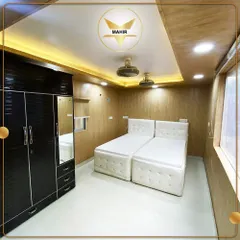 Comfort and style are built into our portable living spaces. This fully furnished bedroom features integrated storage, modern lighting, and two comfortable beds, proving that compact living doesn't mean compromising on luxury.