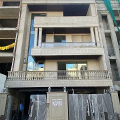 The real-world construction of a neoclassical home, based on our 3D model in image 8. This photo, taken during the final stages, shows the stone cladding, classical columns, and balcony balustrades installed exactly as envisioned in the digital design.