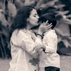There is a unique tenderness in black and white photography. This candid shot of a mother's kiss captures a fleeting, heartfelt moment that transcends color.