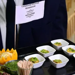 A tray of our signature Tandoori Stuffed Mushrooms, served with fresh green chutney. These bite-sized appetizers are a perfect example of our gourmet take on classic Indian flavours.
