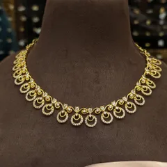 A very delicate and dainty AD stone necklace. This simple piece is perfect for those who prefer minimalist jewellery and can be worn for formal events or small family functions.