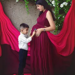 The little doctor is in. The big brother-to-be listens to his sibling's heartbeat with a toy stethoscope, a truly adorable and creative concept for a family maternity photo.