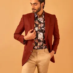 A rich maroon blazer paired with a floral shirt and khaki trousers. This look shows how to expertly layer colors and patterns for a sophisticated yet approachable style.