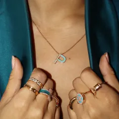 Here is the custom initial pendant paired with a matching ring stack. Personalization is all about creating a cohesive look that feels like you.