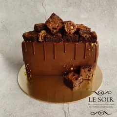 This semi-circle cake is a chocolate explosion. It's a 1 kg Ferrero Crunch cake with a ganache finish, Nutella drip, and a generous pile of my homemade Nutella brownies on top.