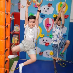 Let your little adventurers challenge themselves! Our climbing and adventure area features a colorful rock wall, gymnastic rings, and rope ladders, all designed to build strength and confidence with soft, padded flooring below.