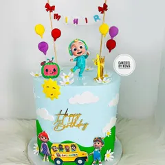 A bright and cheerful Cocomelon cake for Mihir's first birthday. This is one of my most popular designs, featuring JJ, the iconic yellow bus, and a sky full of clouds and balloons.