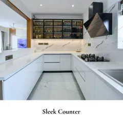 This kitchen reflects a modern aesthetic with a focus on minimalism and functionality, featuring clean white surfaces and an open pass-through to the living area.