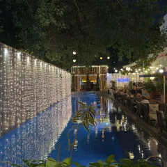 The poolside at Aqua, beautifully decorated with fairy lights for Diwali. The reflection on the water creates a magical, festive ambiance.