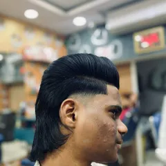 A clean shot of the finished mullet hairstyle. The top is styled for volume while the back is left with natural flow, connected by a smooth fade.