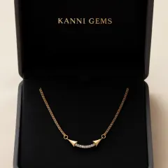 Sometimes, the simplest pieces make the boldest statements. This gold and diamond bar necklace, nestled in its box, adds just the right sparkle to your neckline, turning everyday moments into celebrations of style.