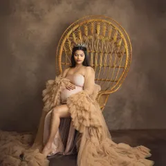Every mother is a queen, and in my studio, we make that a reality. This portrait, with the regal peacock chair and a flowing tulle gown, is all about celebrating your strength and grace in a timeless, elegant style.