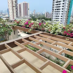 A stunning terrace garden we designed, bringing a burst of color against the Mumbai skyline. We used a mix of vibrant bougainvillea in custom planters to create a luxurious and inviting outdoor space perfect for relaxing.