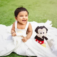 A big, joyful laugh from this little one during his outdoor session with his friend Mickey Mouse.