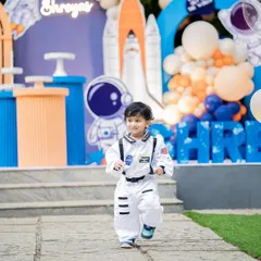 It's not just about the decor, it's about the memories. I love seeing the birthday child fully immersed in the theme, like this little astronaut ready for an adventure at his space-themed party.