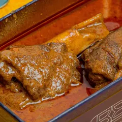 I meticulously slow-cook my Nalli Nihari, allowing the tender lamb shanks to simmer in a fragrant blend of spices for a luscious depth of flavor.