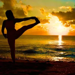 Practicing a standing balance pose as the sun sets over the ocean. These moments in nature are where I feel most connected and at peace.