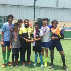 Our U-16 football champions with their coaches, holding the Stallion Football Cup trophy. We are proud to guide these talented young athletes.