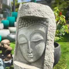 This unique Buddha face mural is carved directly into a rough block of stone. It symbolizes enlightenment and detachment, making it a powerful and artistic statement piece for a wall or garden.