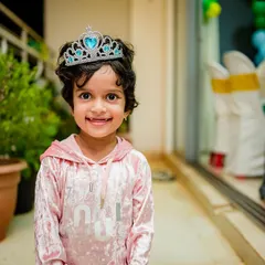 A sweet portrait of the birthday girl, looking like a little princess in her tiara and smiling for the camera.