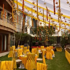 An outdoor Mehendi ceremony comes alive with the right decor. We used vibrant yellow drapes and marigold garlands to create a festive canopy, transforming a simple lawn into a bright and cheerful celebration space.